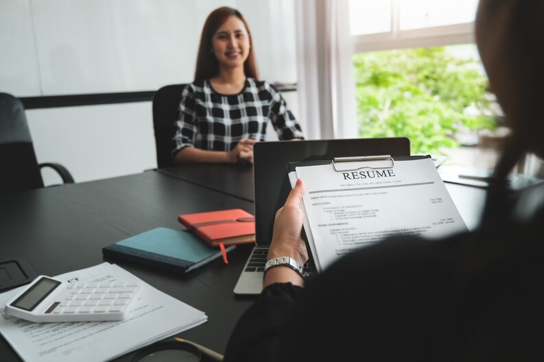 Well-structured resume featuring internship experiences being reviewed by a recruiter.