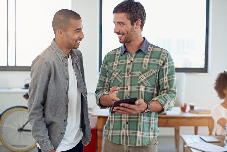A professional mentor guiding an intern, offering constructive feedback on their work.
