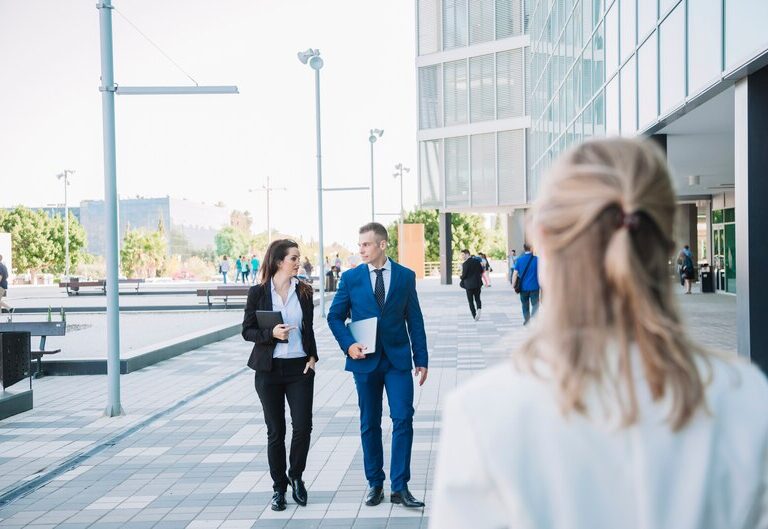 A young professional standing at a career crossroads with multiple career paths illustrated