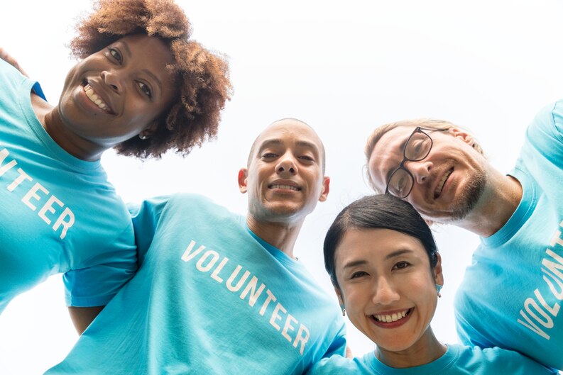 A diverse group of community service professionals standing together.