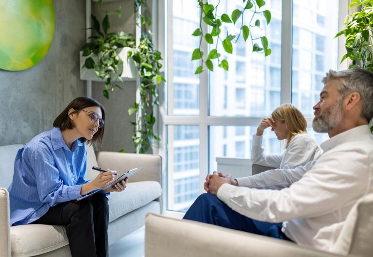 A mental health professional consulting with a patient in a calm environment.