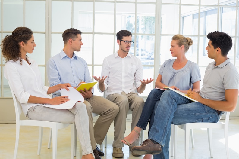 A team of mental health professionals discussing a patient case.