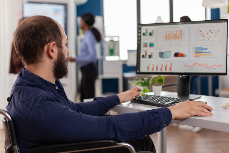 : A professional working on a laptop, analyzing data and using digital tools.