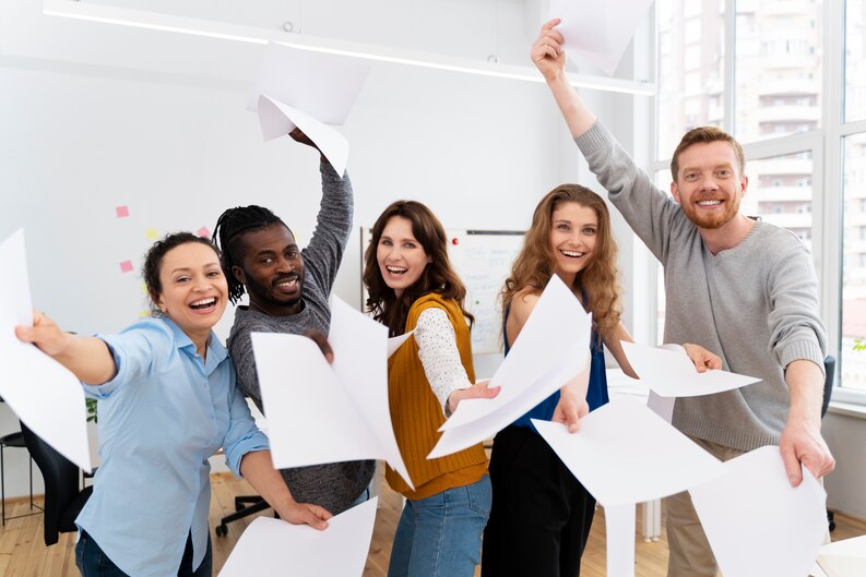 A group of students celebrating their successful completion of work placements with certificates in hand.