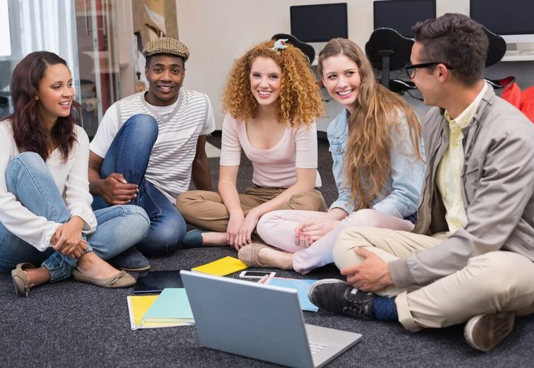 Youth work students participating in a workshop, engaging in group discussions and activities.