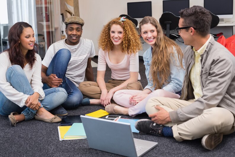 Youth work students participating in a workshop, engaging in group discussions and activities.