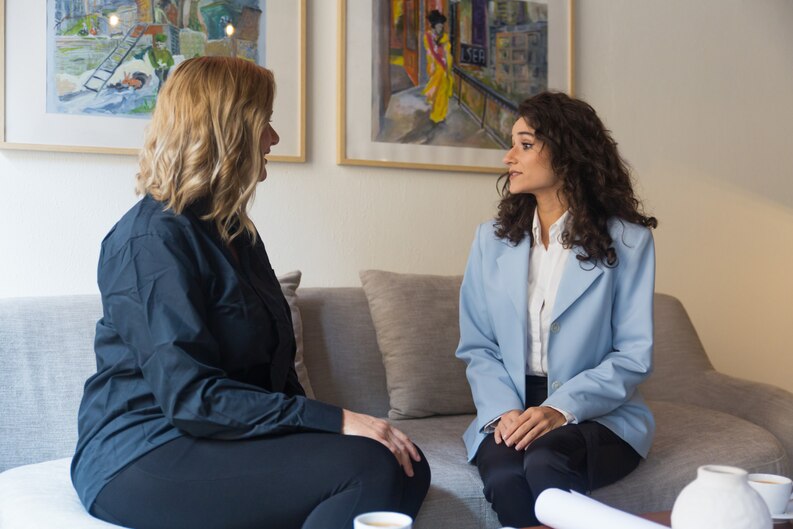 A mental health professional supporting a patient during a counseling session.