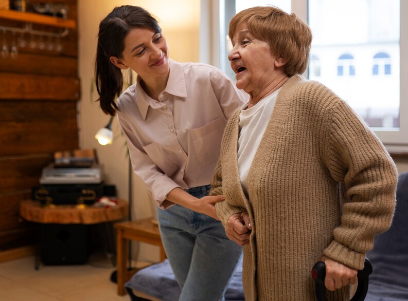 A compassionate caregiver assisting an elderly individual in a care home setting.