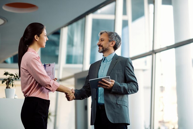 Business professionals shaking hands in agreement