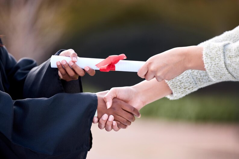 Successful graduate shaking hands after completion