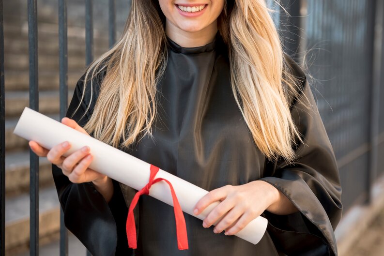 Smiling student holding certificate of completion.