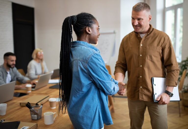 Training provider and student shaking hands in a successful partnership