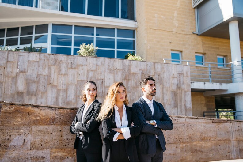 Young graduates walking confidently toward buildings labeled AI, Cybersecurity, Health Tech, and Sustainability.