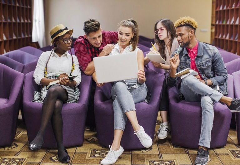A group of diverse Australian students using AR headsets, robotics kits, and digital touchscreens in a futuristic classroom.