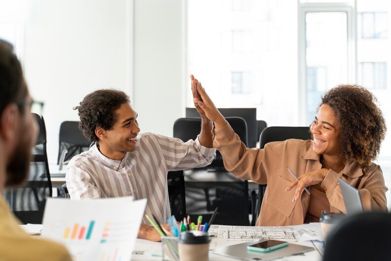 A diverse team celebrating after completing a successful project