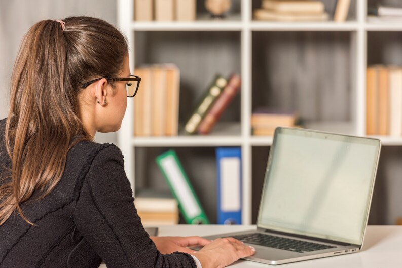 Student updating resume on a laptop