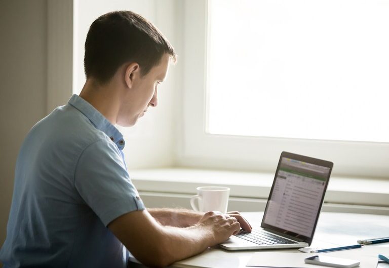Student updating resume on a laptop