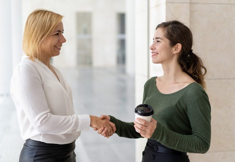 Confident student intern meeting mentor