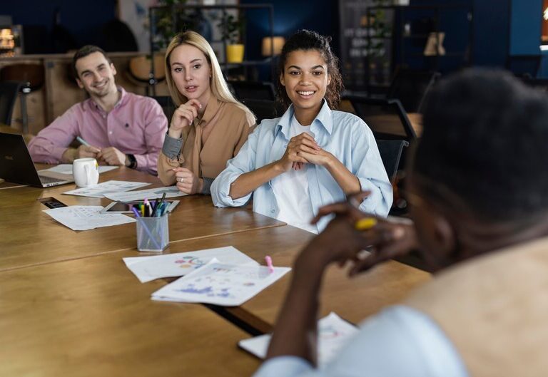 Diverse students working in a corporate office during internship