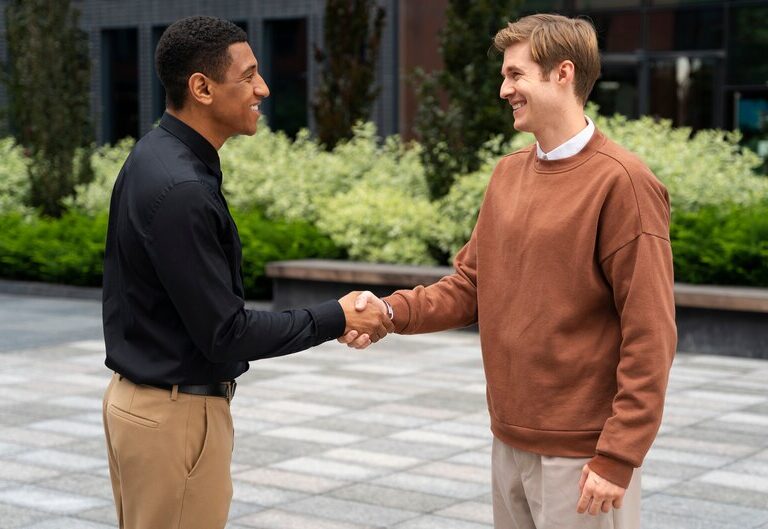Student and industry professional shaking hands